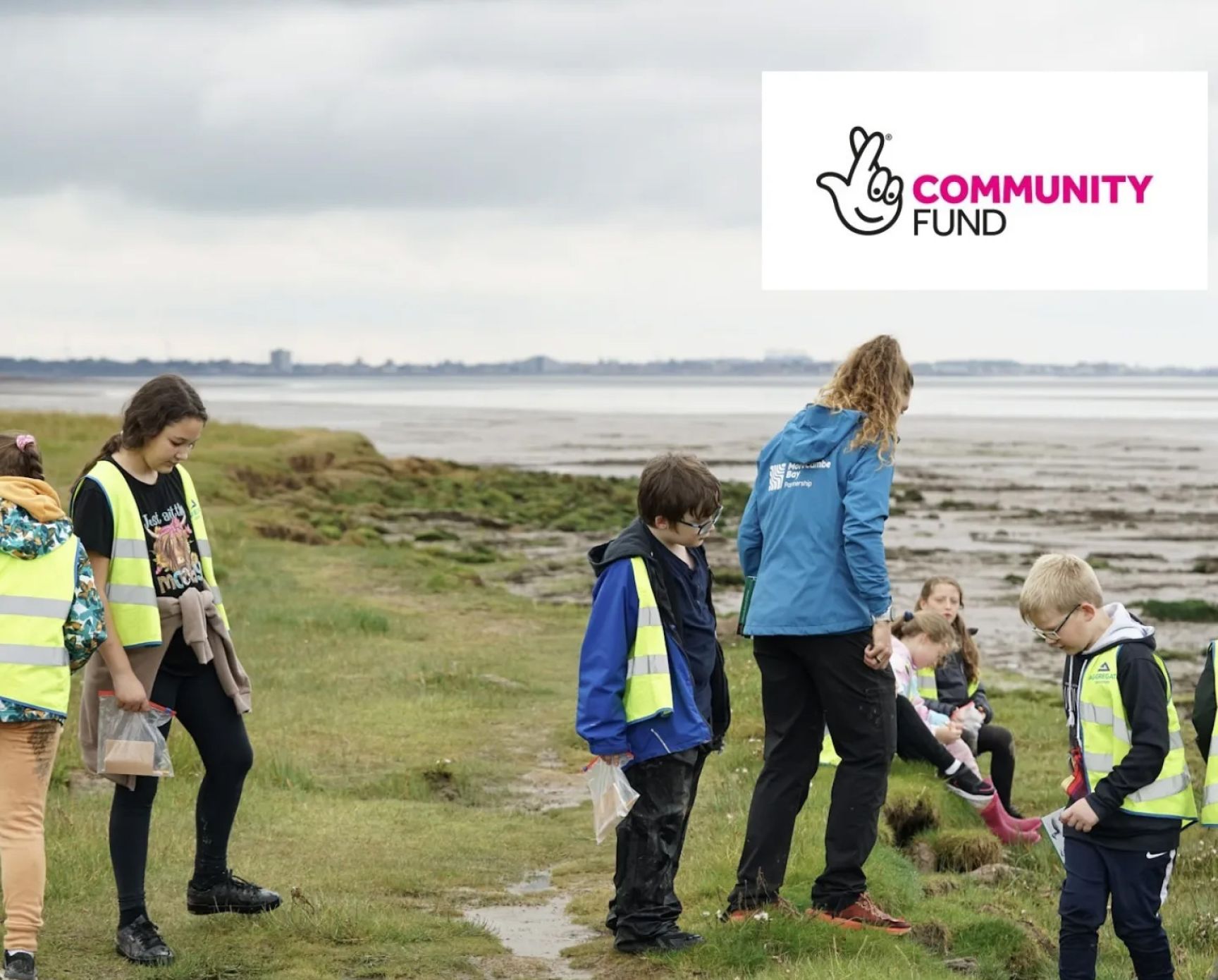 Children and an adult by the shore